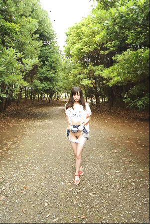 Riko Tabe shows boobs and trimmed pussy under skirt in a park.